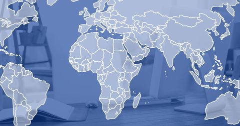 World map overlay on modern office desk