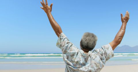 Senior African American Man Celebrating on Sunny Beach - Download Free Stock Images Pikwizard.com