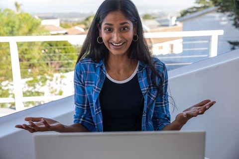 Young woman engaging in video call from scenic balcony