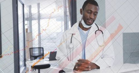 Sitting clinic physician at desk wearing lab coat and stethoscope with trendline overlay