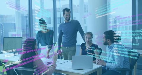 Software developers collaborating around laptop with code overlay in modern office meeting