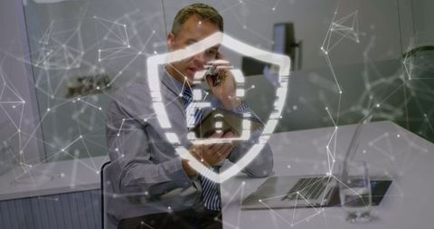 Businessman discussing cybersecurity with digital protection graphics