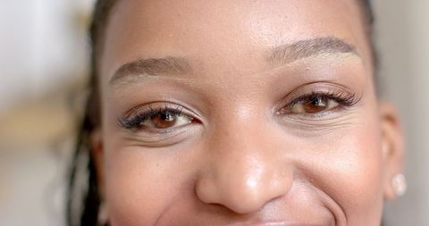 Confident Young Woman with Radiant Smile and Natural Makeup