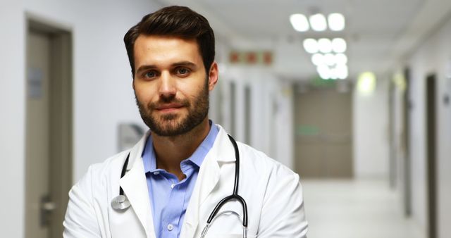 Confident Doctor with Stethoscope in Hospital Corridor - Download Free Stock Images Pikwizard.com