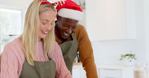 Diverse couple joyfully baking together for the holidays