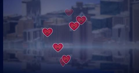 Floating heart icons against urban cityscape