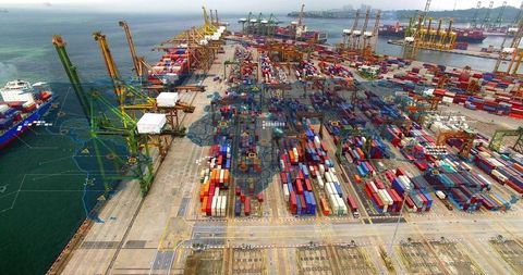 Aerial container terminal showing global shipping network with digital route overlay