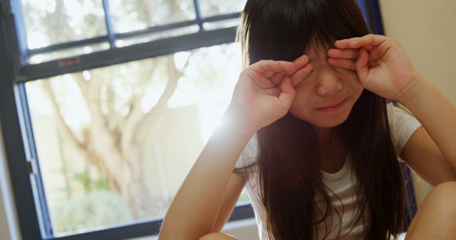 Tired Young Girl Rubbing Eyes with Bright Window Background - Download Free Stock Images Pikwizard.com