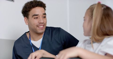 Friendly medical consultation young nurse with child patient