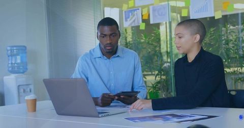 Business Professionals Analyzing Charts in Modern Office