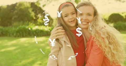 Smiling mother embracing daughter in sunlit garden golden hour with currency icons