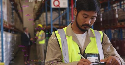 Recording inventory on clipboard in warehouse aisle wearing high visibility vest and badge