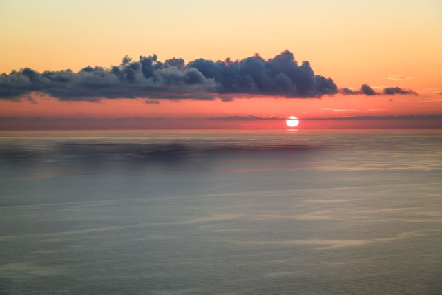 Serene Sunset Over Calm Ocean with Clouds - Download Free Stock Photos Pikwizard.com