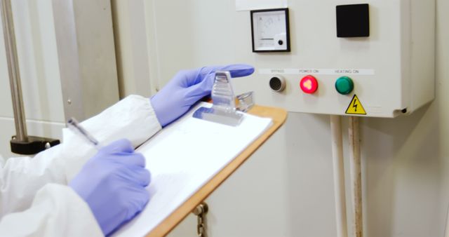 Scientist Recording Data with Control Panel in Laboratory - Download Free Stock Images Pikwizard.com