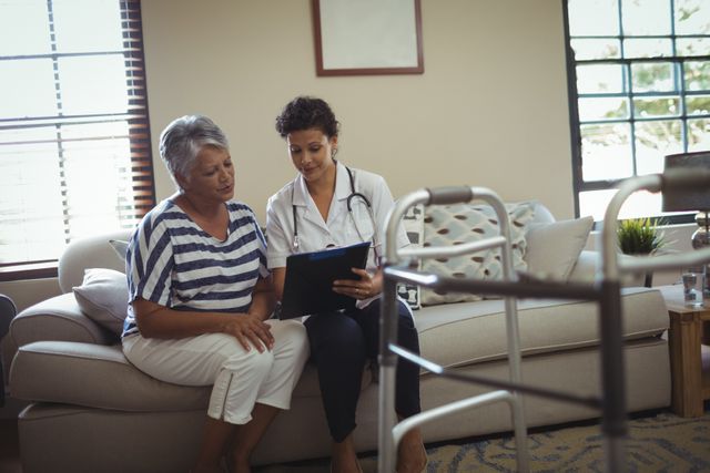 Female Doctor Consulting Senior Woman at Home - Download Free Stock Images Pikwizard.com