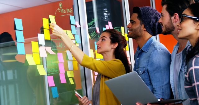 Young Team Brainstorming and Collaborating with Sticky Notes in Modern Office - Download Free Stock Images Pikwizard.com