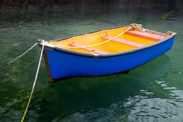 Colorful Rowboat Floating in Peaceful Harbor - Download Free Stock Photos Pikwizard.com