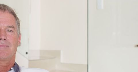 Modern living space with minimalist glass wall and white stairs