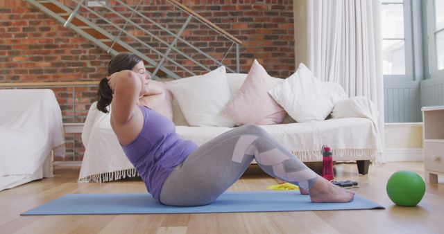 Woman Exercising At Home Doing Sit-Ups On Yoga Mat - Download Free Stock Images Pikwizard.com