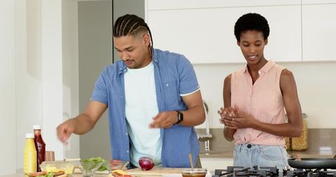 Couple Preparing Fresh Salad in Modern Kitchen Setting