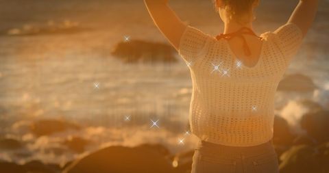 Woman Enjoying Sunset by Ocean with Radiating Sunlight - Download Free Stock Images Pikwizard.com