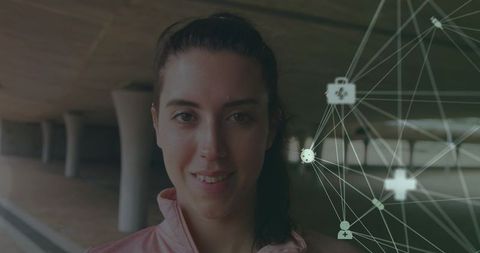 Young woman in pink jacket at urban underpass with healthcare network overlay