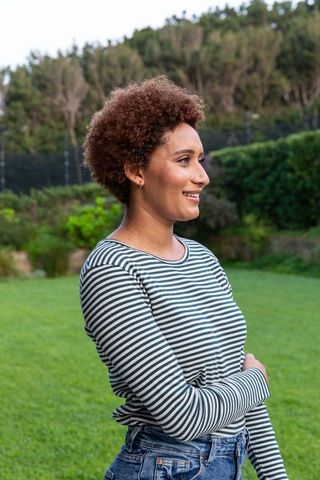Woman enjoying nature in casual outfit at peaceful garden
