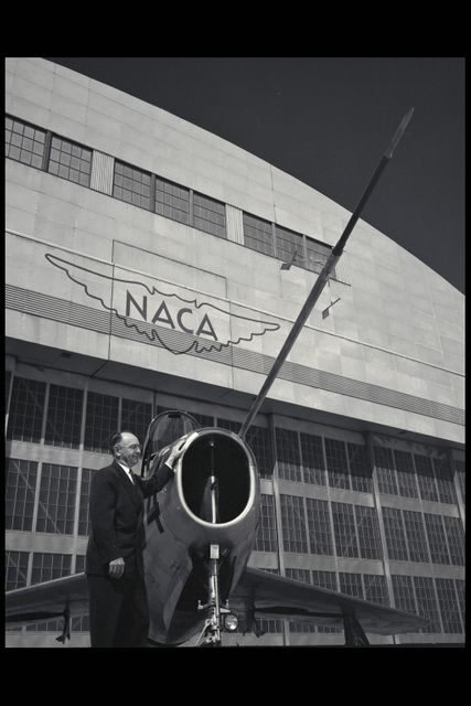 Man Standing Next to F-84 Aircraft Outside NACA Hangar - Download Free Stock Images Pikwizard.com