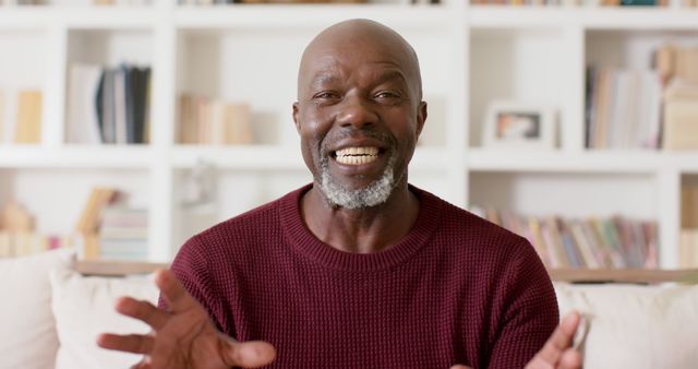 Smiling Man Sitting Indoors Backdrop of White Shelves - Download Free Stock Images Pikwizard.com