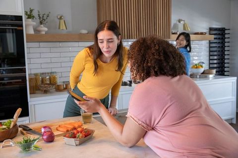 Diverse Female Friends Cooking Harmoniously in Modern Kitchen