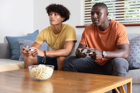 Diverse friends engaging in gaming session at home