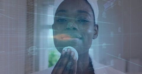 Applying skincare with holographic mirror overlay, woman pressing cotton pad