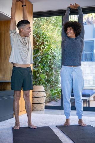 Diverse Friends Enjoying Yoga Together at Home for Relaxation and Wellness