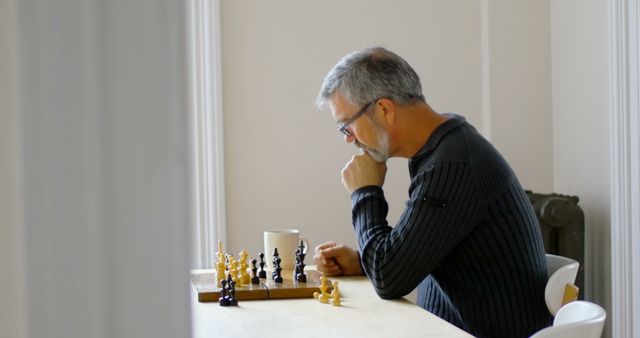 Mature Man Thinking and Playing Chess Alone at Home - Download Free Stock Images Pikwizard.com