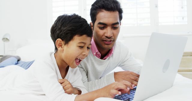 Father and Son Bonding Over Laptop on Bright Sunny Morning - Download Free Stock Images Pikwizard.com