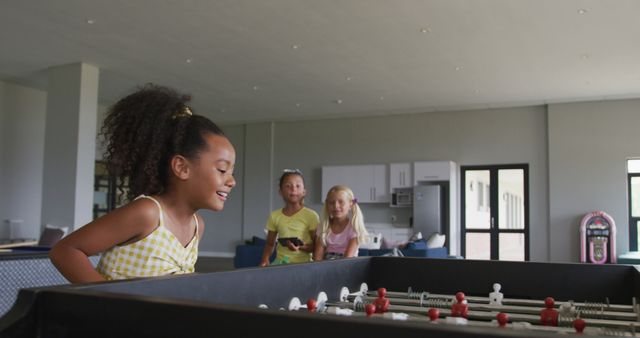 Happy Children Playing Foosball in Modern Game Room - Download Free Stock Images Pikwizard.com