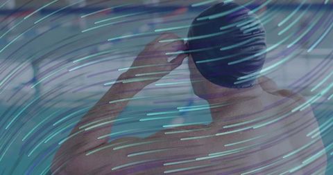 Male Swimmer Adjusting Swim Cap in Indoor Pool with Neon Motion Trails