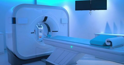 Advanced mri ct scanner with motorized patient table and teal pad in radiology suite