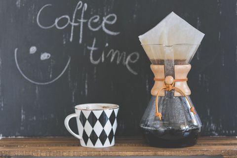 Rustic coffee brewing with cup and blackboard