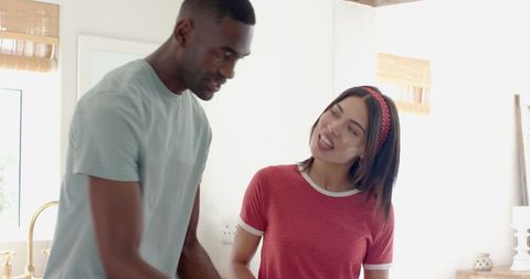 Diverse Couple Collaborating on Meal Preparation in Modern Kitchen