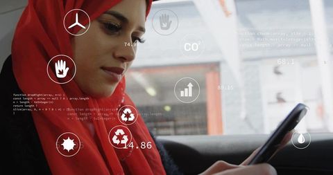 Young woman in red hijab scrolling smartphone with ar overlays in urban car backseat