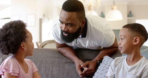African American Father and Children Communicating at Home