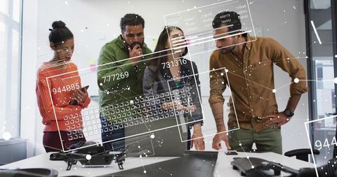 Team reviewing drone prototype with augmented data overlays in modern office collaboration