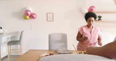 Friends Gathering in Stylish Dining Room Decorated with Balloons