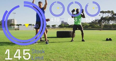 Group outdoor training flipping tractor tire and lifting dumbbells with hud fitness metrics