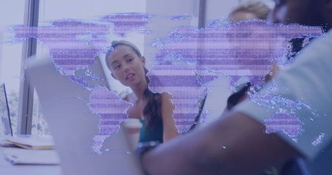 Dynamic Office Team Strategy Meeting with World Map Overlay