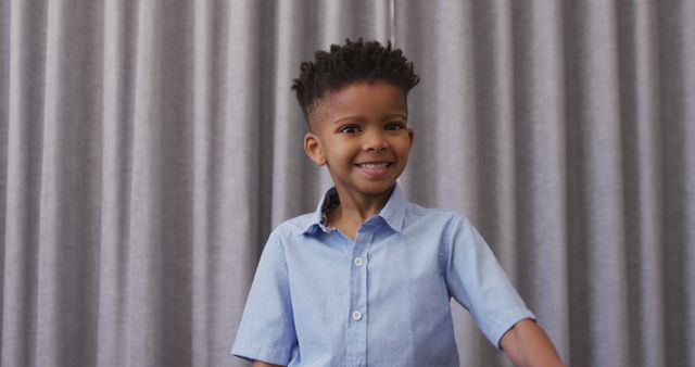 Portrait of happy african american boy using sign language and smiling. Spending quality time at home.