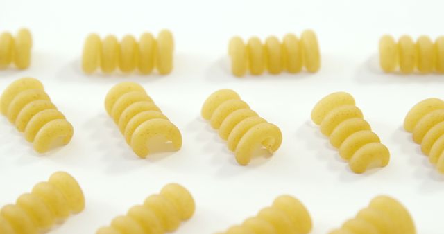 Raw Spiral Pasta Arranged in Rows on White Background - Download Free Stock Images Pikwizard.com