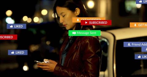Asian woman checking smartphone on night city street with social media notifications