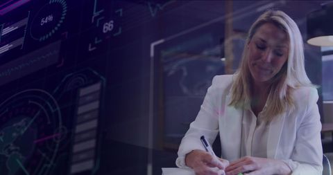Professional Woman Writing in Modern Office with Data Overlay